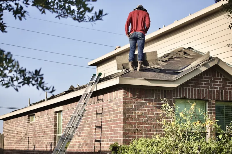 Professional roofer working on a residential roof in Lake Howard